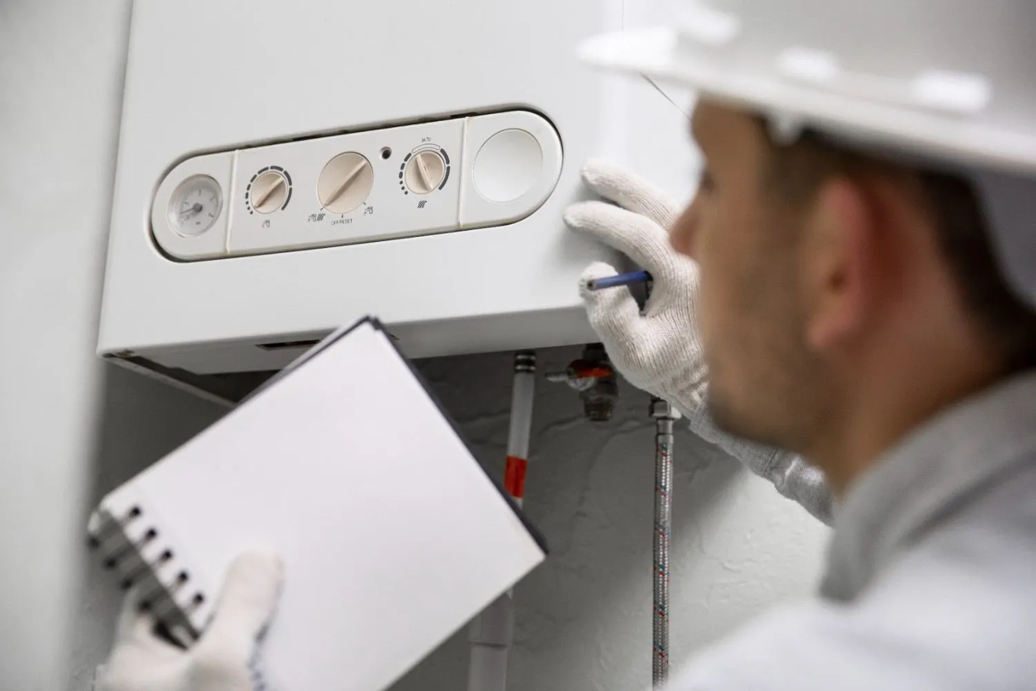 Technician checking a wall-mounted water heater